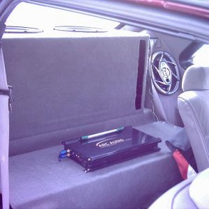 a view of teh amp rack in my brother's 93 stang
