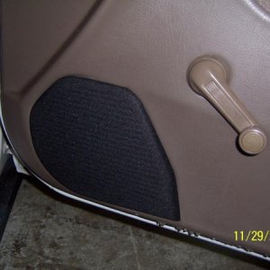 Black Grill cloth on top of midrange speaker in door
