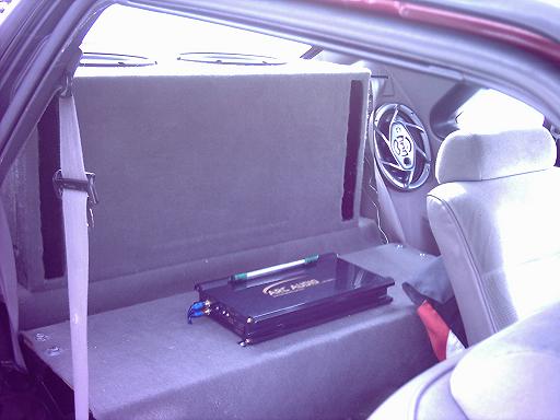 a view of teh amp rack in my brother's 93 stang